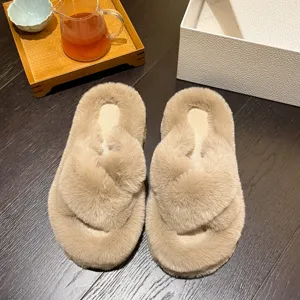 Detailed top view of plush fuzzy cross-strap house slippers in a cozy lifestyle setting.