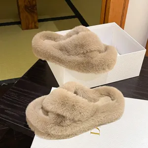 Detail view of beige faux fur cross-strap slippers for cozy home and outdoor wear