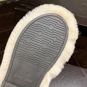 Macro view of anti-slip rubber sole with faux fur lining on these warm slippers