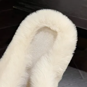 Close-up detail showing the soft and fluffy white faux fur texture of winter slippers