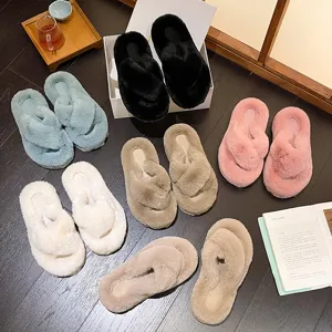 Variety of plush cross strap slippers in pastel colors displayed on wooden floor