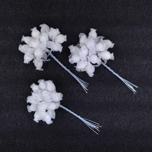 Close-up of white 12-head artificial rosebud clusters perfect for DIY wedding crafts.