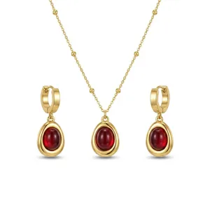 Elegant gold-plated stainless steel jewelry set featuring oval red stone pendants.