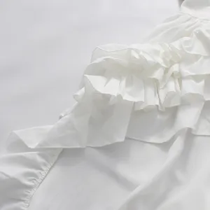 Close-up of elegant multi-layered white ruffles on a stylish evening party dress