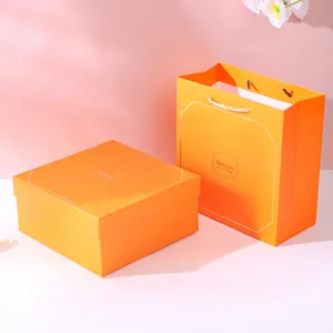 Premium orange gift box and matching paper tote bag set with Good Luck greeting print