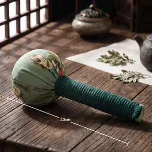 Detail view of a 20cm traditional meridian massage hammer with green floral pattern.