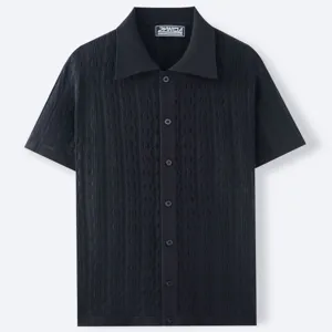 Detail view of black short-sleeved knit polo shirt with vertical jacquard texture