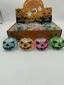 Detailed view of colorful glitter Halloween pumpkin squishy toys in display box