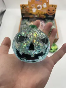 Close-up detail of a glittery translucent Halloween pumpkin squishy toy held in hand