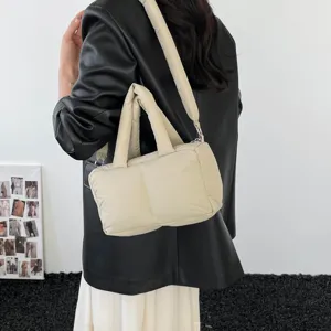 Stylish beige padded tote bag for women, featuring a soft texture and crossbody strap.