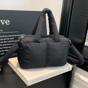 Stylish minimalist black puffer tote bag with a soft quilted texture for modern women