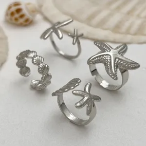 Silberne offene Ringe mit Seestern- und Muschelmuster für den Sommerurlaub am Meer am Strand