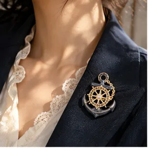 Exquisite vintage nautical anchor brooch with rhinestone ship wheel on a navy suit blazer