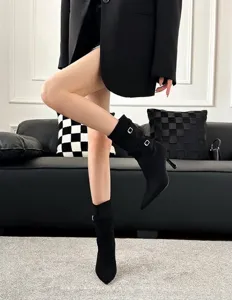 Detailed shot of black stiletto ankle boots with buckle and slouchy slouch design