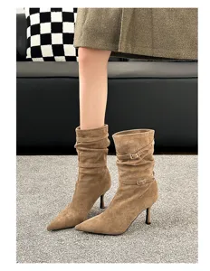 Detail view of maple brown pointed toe slouchy boots with stylish metal buckle straps