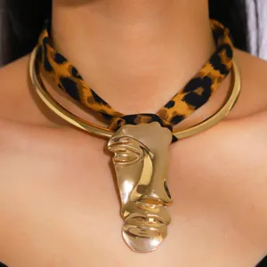 Vintage abstract face pendant necklace with leopard print cord and gold metal collar