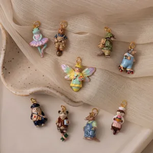 Detailed assortment of colorful enamel animal charms on a beige fabric