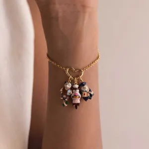 Detailed view of three cute animal enamel charms on a gold-plated heart bracelet