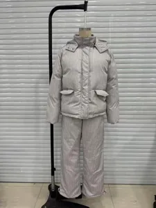 Full view of a striped hooded puffer jacket and wide-leg trousers on a mannequin.