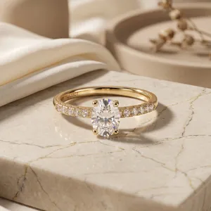 Detailed macro view of an elegant oval-cut moissanite engagement ring on a marble stone