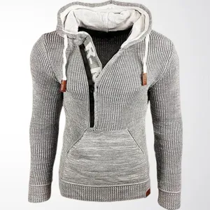 Detail of grey men's ribbed knitted hoodie with half-zip and functional drawstring hood