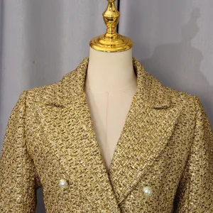 Detailed close-up of elegant gold tweed jacket featuring notch lapel and pearl buttons