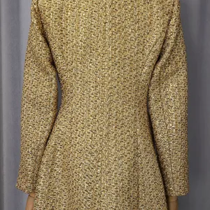 Detail view of luxury gold metallic tweed fabric on the back of a slim fit long coat