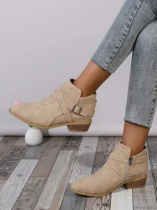 Side detail view of beige pointed toe ankle boots featuring a buckle strap and zipper