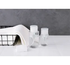 Set of two clear press-type dispensing bottles for travel skincare and toner storage.
