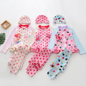 Detailed view of three colorful girls' long-sleeved mermaid polka dot swimwear sets