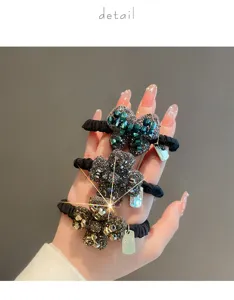 Rhinestone clover hair ties for women, elegant black elastic bands with metal charms.