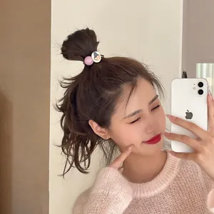 Detailed view of cute Korean ins style hair tie with cartoon button and purple bead.