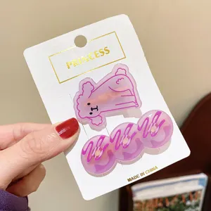 Cute purple acrylic hair clip set featuring poodle and donut designs on card display.