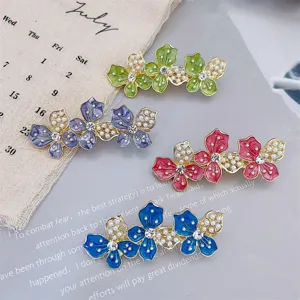 Floral hairpin set with colorful enamel flowers, faux pearls, and sparkling rhinestones.