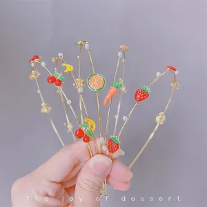Detailed close-up of sweet fruit metal headbands with enamel charms and pearls for cute looks.