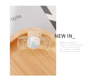 Transparent resin hair claw clip with iridescent pearl decoration for women daily hair styling.