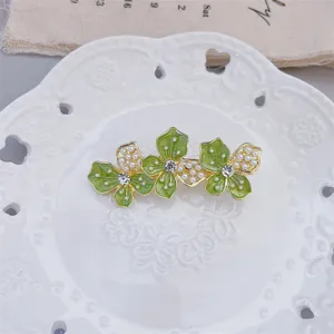 Green enamel flower hair clip with pearls and rhinestones exquisite detail shot view