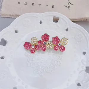 Elegant pink enamel flower hair clip with pearls and rhinestones for women summer styling.