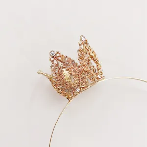 Gold crown headband detail, delicate leaf filigree design with sparkling white crystals inlay.