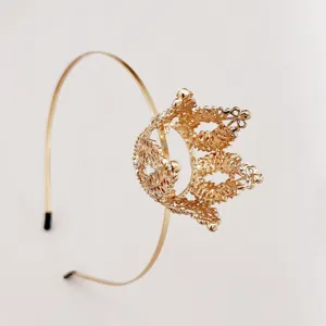 Gold crown headband detail shot, exquisite hollow metal design, elegant girls hair accessory.