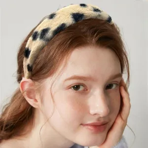 Close-up of the wide plush leopard print headband detail, showing soft texture and cozy wear.
