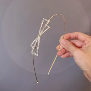 Exquisite thin metal rhinestone bow headband, delicate detail closeup for elegant daily wear.