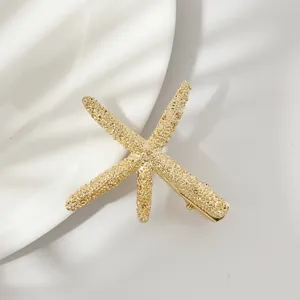 Gold starfish hairpin detail shot, elegant metal hair clip for women and daily styling.