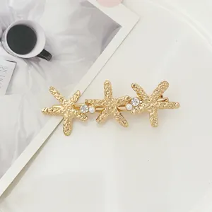 Gold triple starfish hair clip with pearls and rhinestones, elegant hairpin for women and girls.