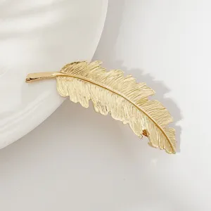 Gold feather hair clip detail view, elegant metal hairpin for women and girls daily styling.