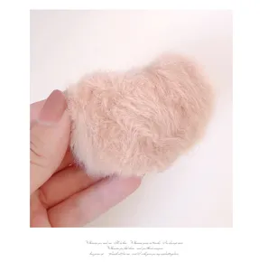 Close-up of cute pink plush heart hair clip detail, soft fuzzy texture, sweet girl style.