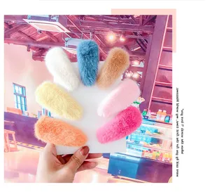 Detail view of cute macaron plush hair clips showcasing soft furry texture and vibrant colors.