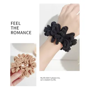 Detailed view of the plush velvet hair scrunchie, soft texture and solid color design.