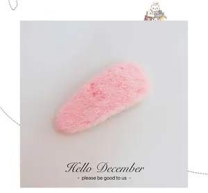 Close-up detail of a cute pink plush waterdrop hair clip, soft macaron fuzz texture.