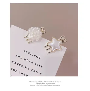 Detailed view of mini floral and star hair claws, sweet pearl white design for daily styling.